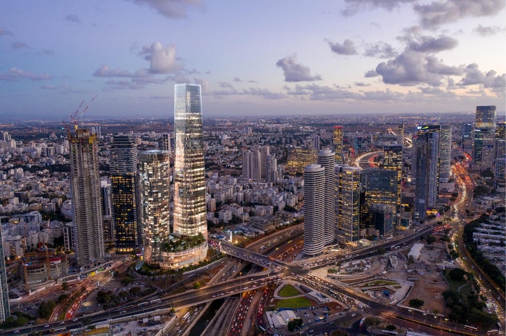 הדמיה אווירית של פרויקט Beyond עם מגדלי זכוכית מוארים במרכז המטרופולין.